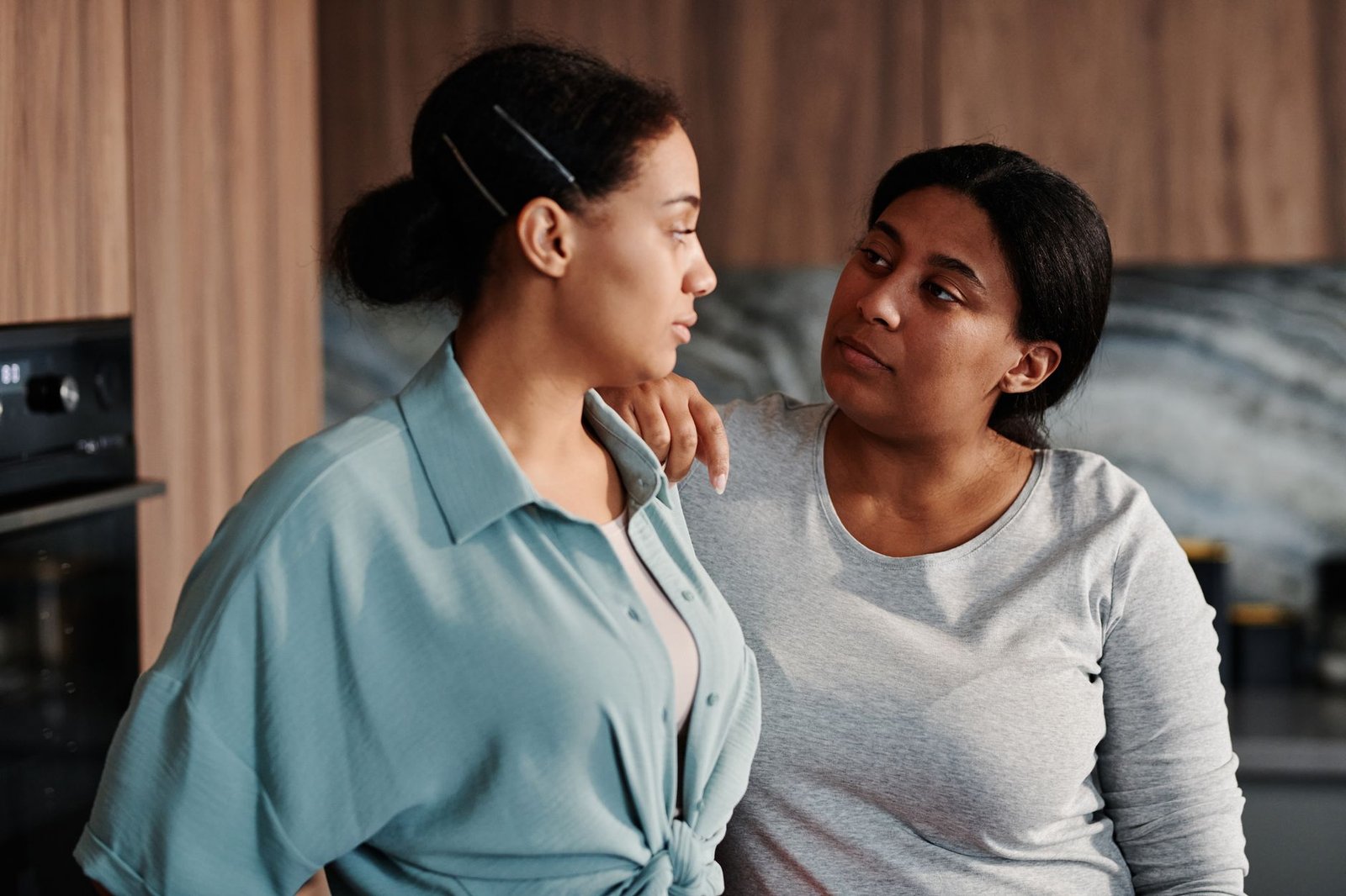 Two friends sitting closely, offering comfort and support