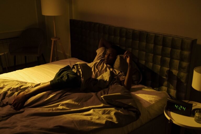 Person lying awake in bed at night, unable to sleep