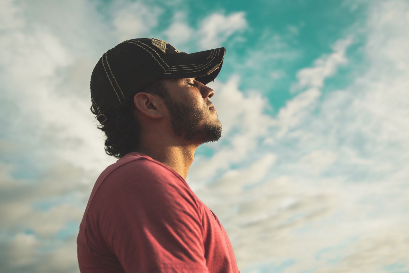 Person standing outside taking a deep, calming breath