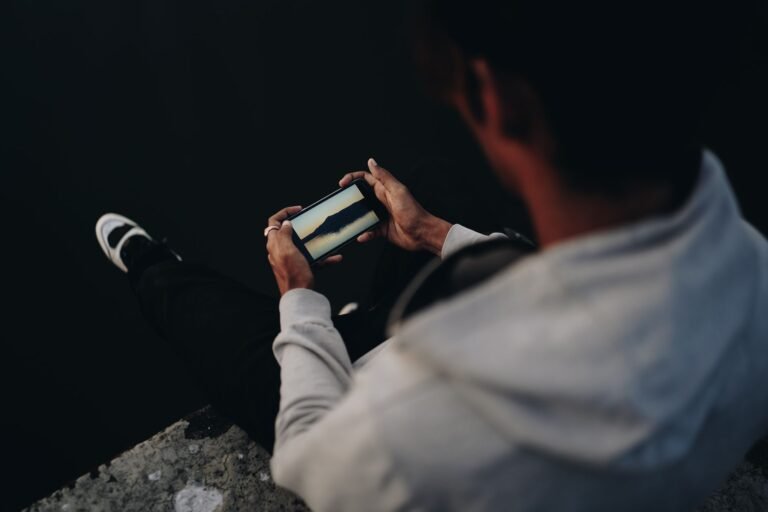 Person scrolling on their phone, feeling down after comparing themselves to others online