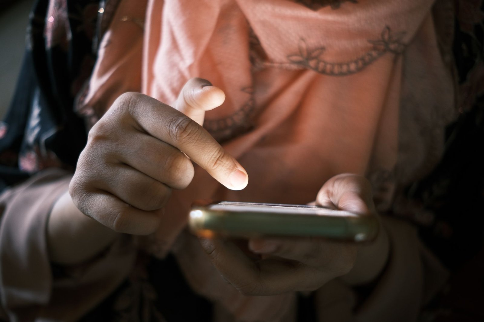 Person scrolling through social media on smartphone, feeling disconnected