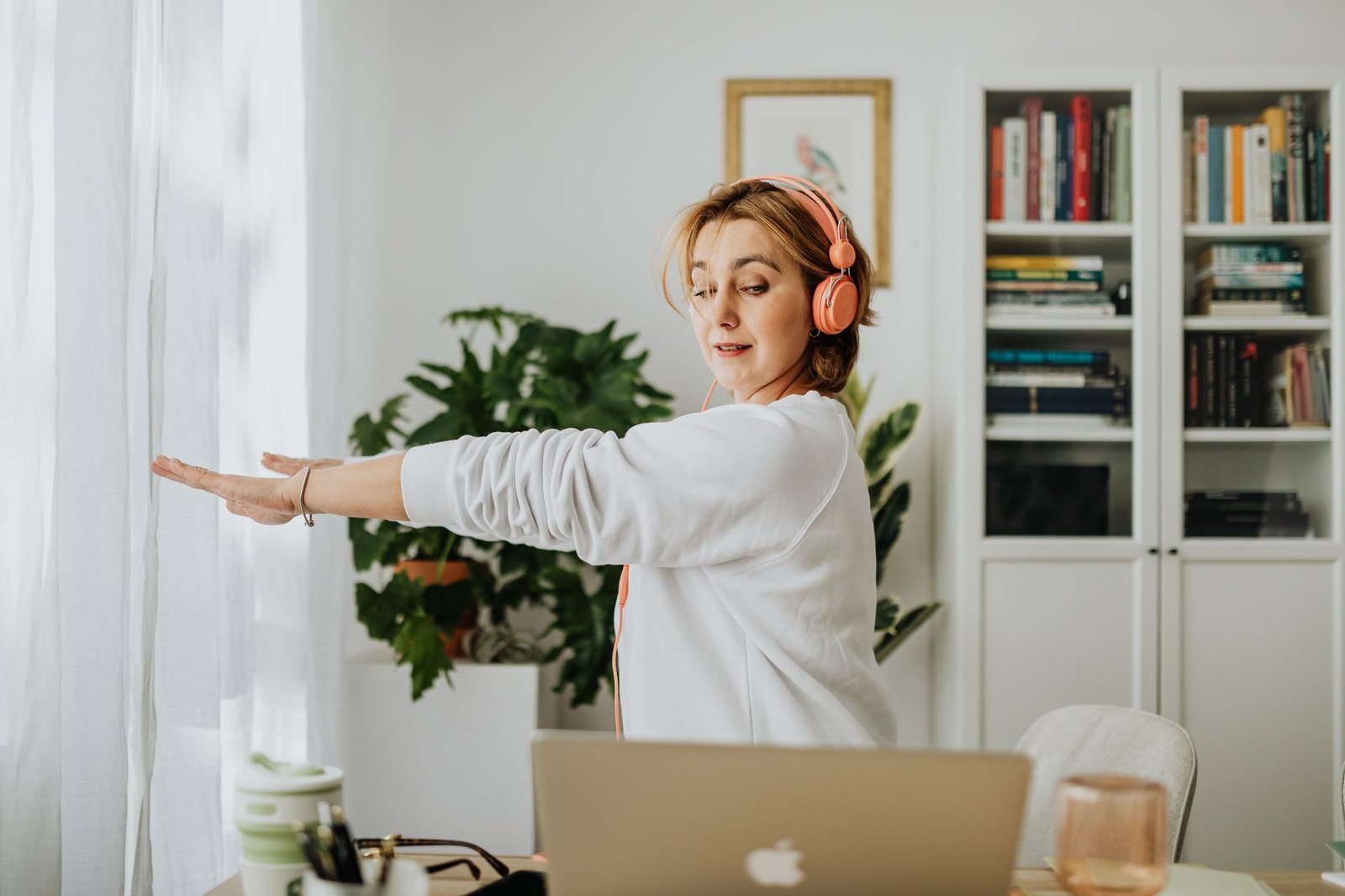 Person adjusting posture and stretching at a desk