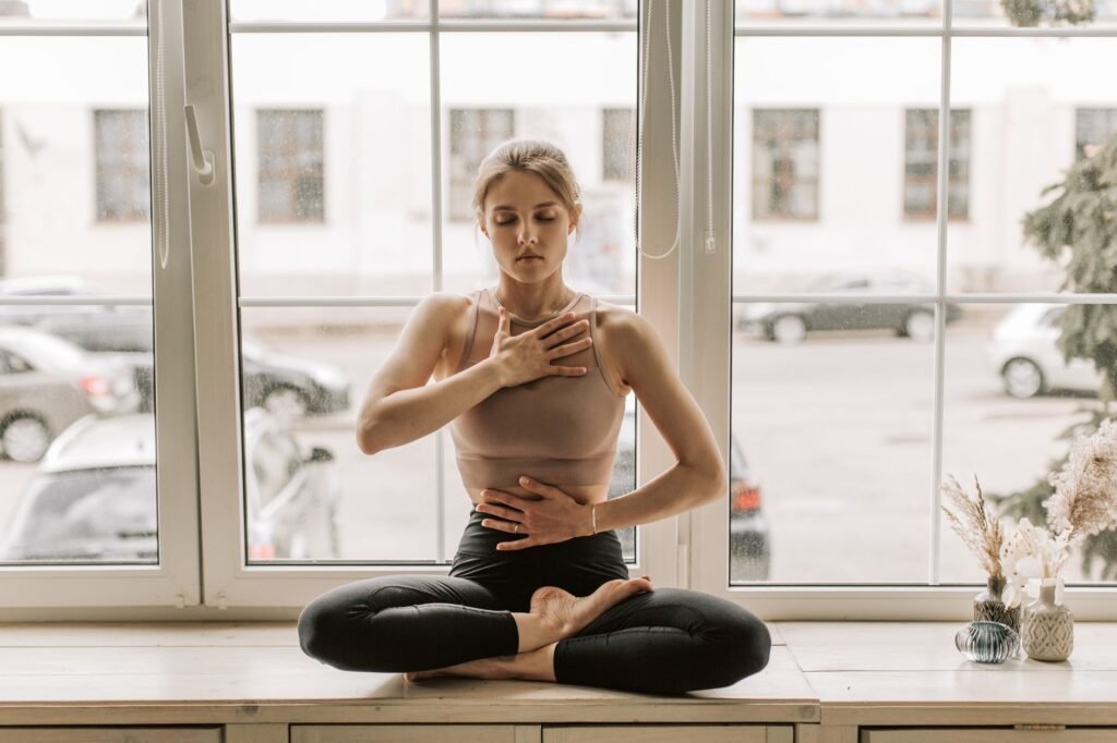 Person standing with shoulders relaxed and chest open, taking a calm deep breath