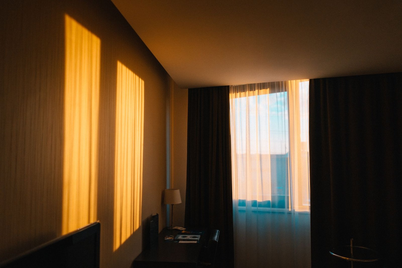 Soft morning sunlight coming through a bedroom window representing circadian rhythm cues
