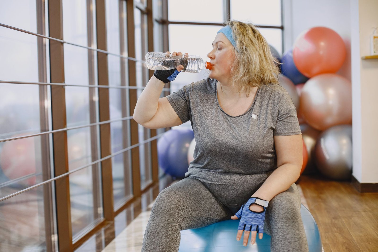 Woman feeling fatigued while drinking a glass of water