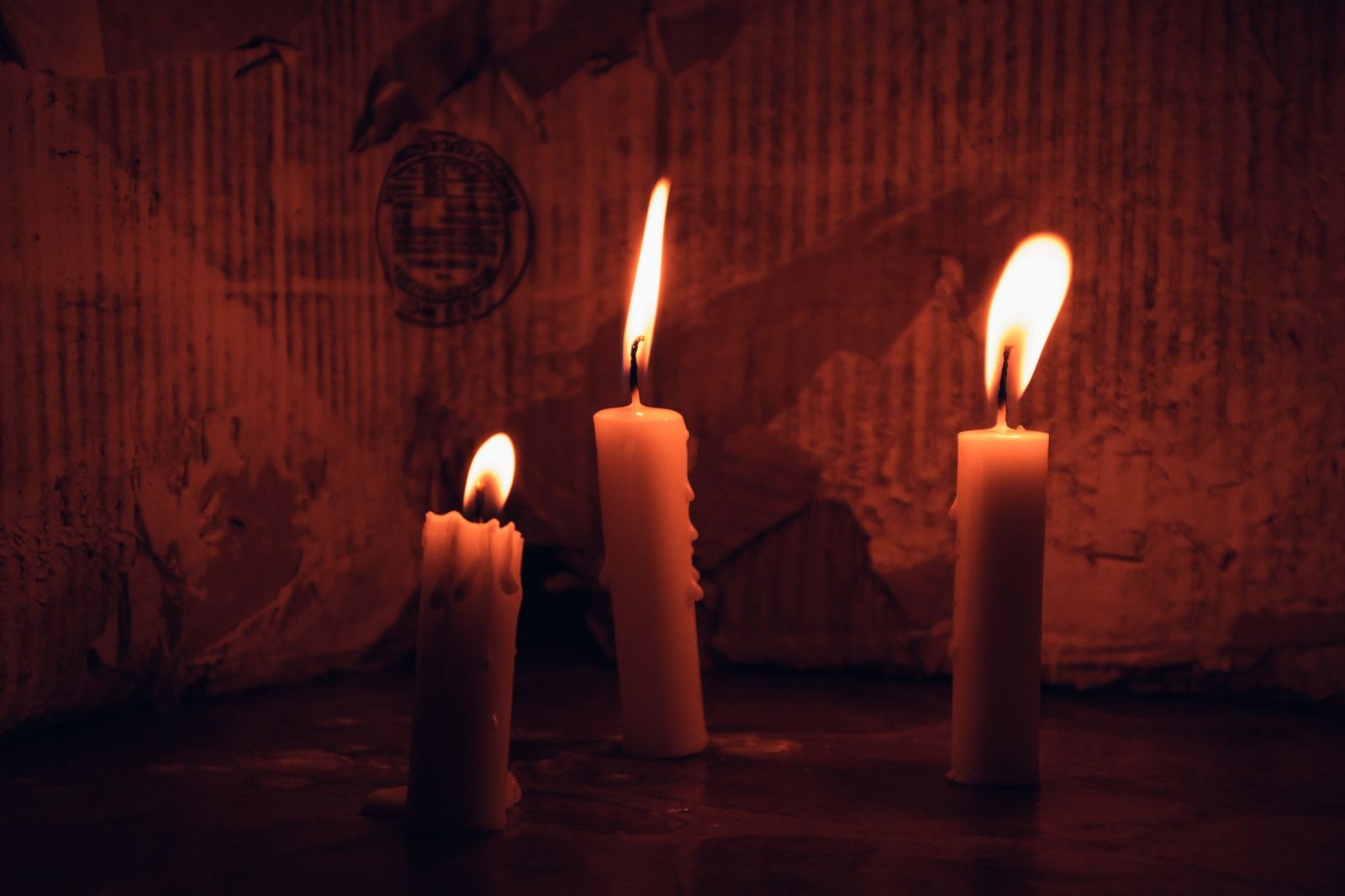 A lit candle in a calm, quiet room symbolizing reflection