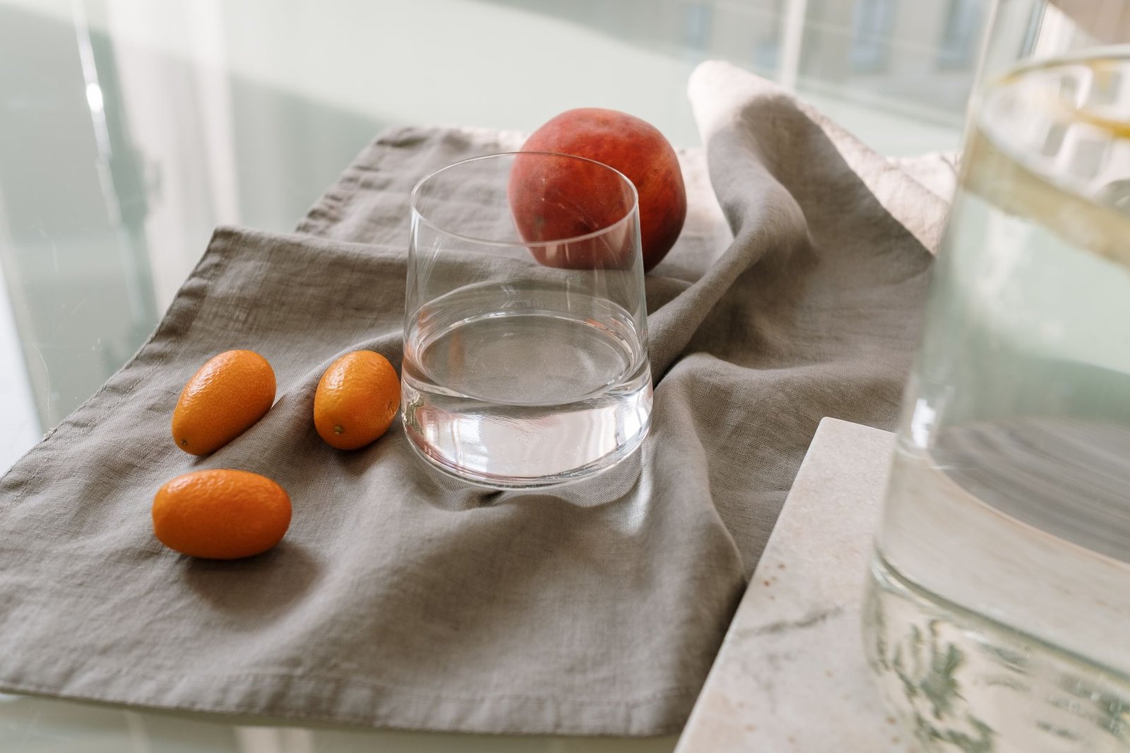 Glass of water next to a plate of colorful, nutritious food