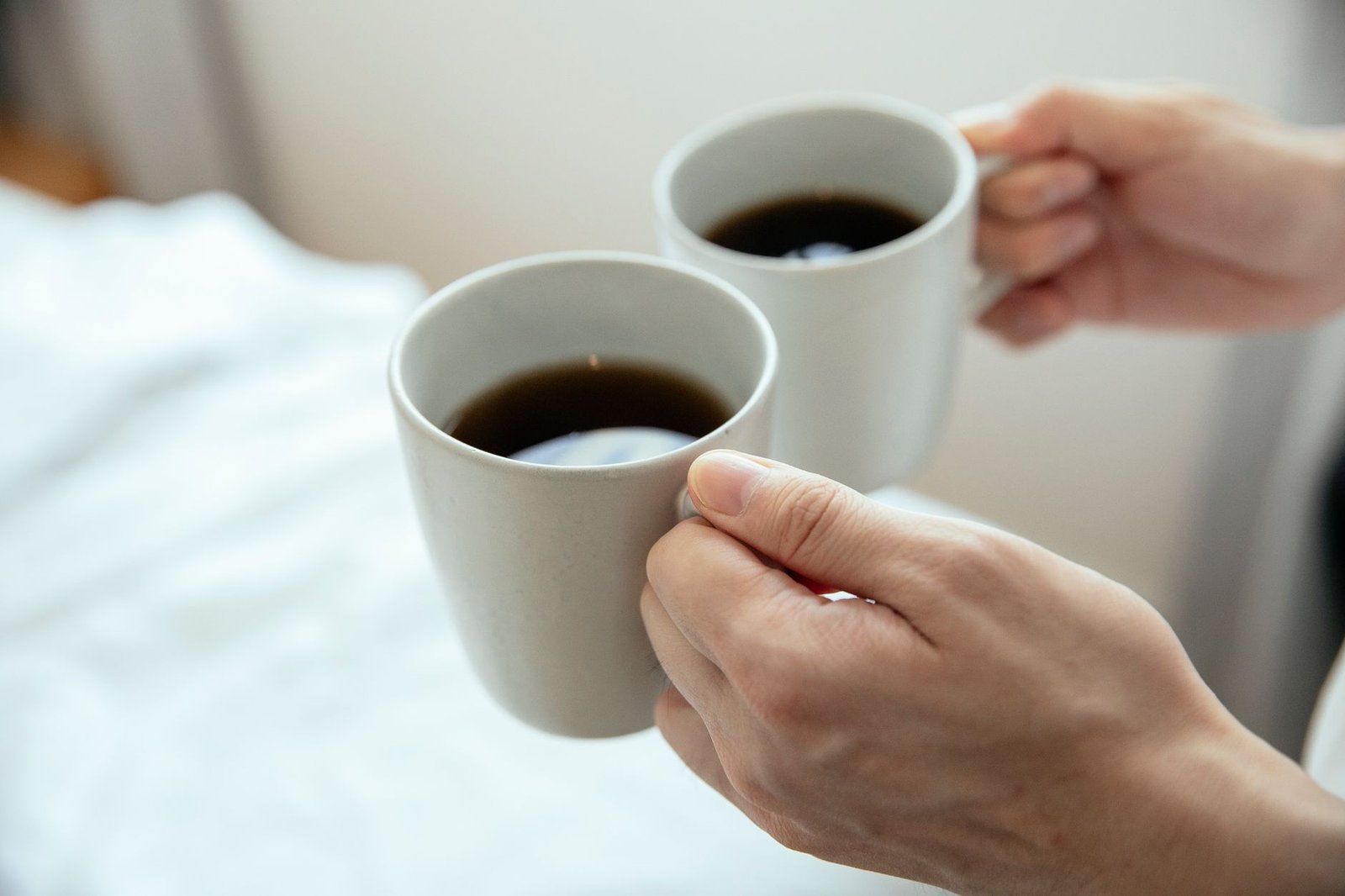 Hands wrapped around a warm coffee mug, a small everyday comfort