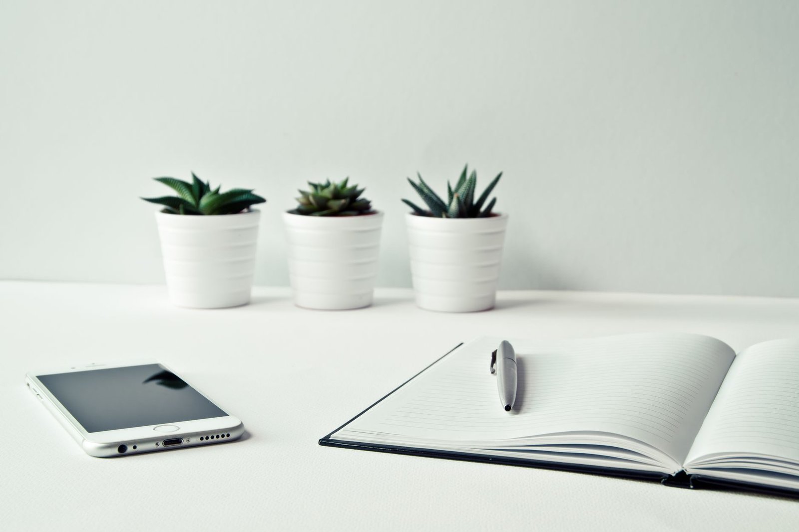 A simple notebook and phone on a desk for jotting quick notes