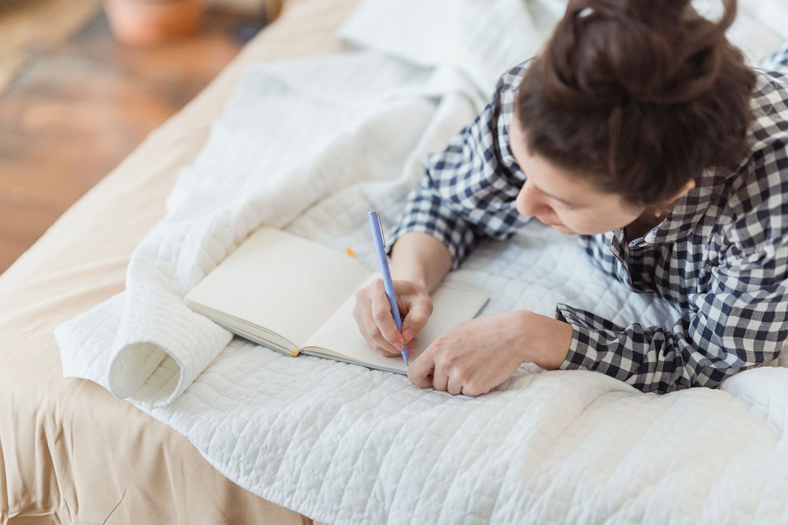 Woman writing in a notebook while reflecting on her core personal values
